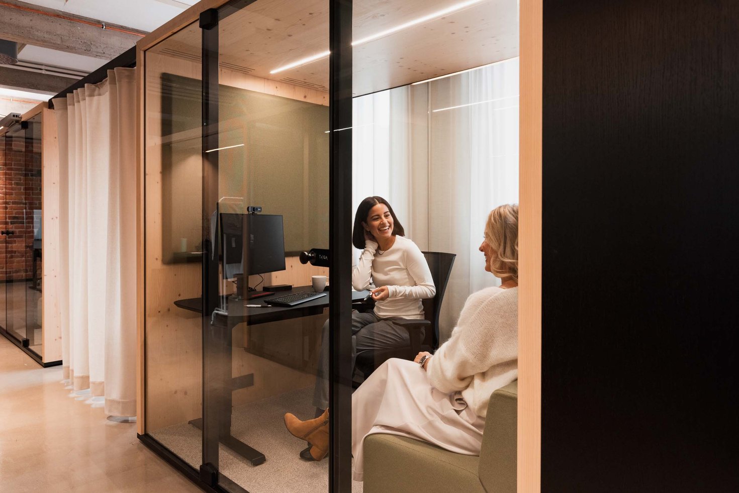 Two people meeting in an office pod